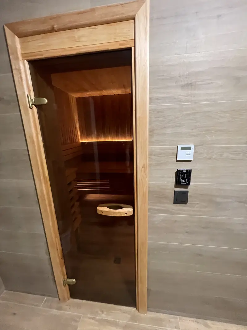 Sauna door with a large glass panel being installed